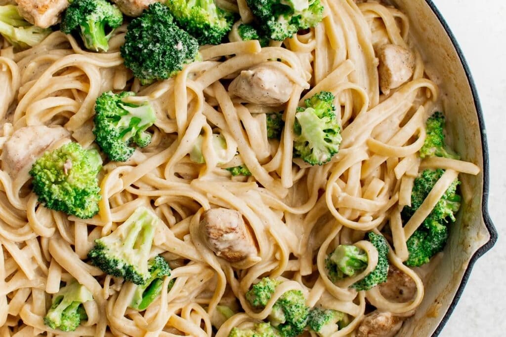 Chicken broccoli Alfredo in a skillet.