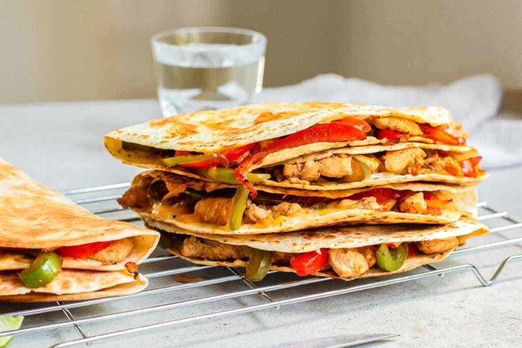 Chicken fajita quesadillas on a cooling rack.