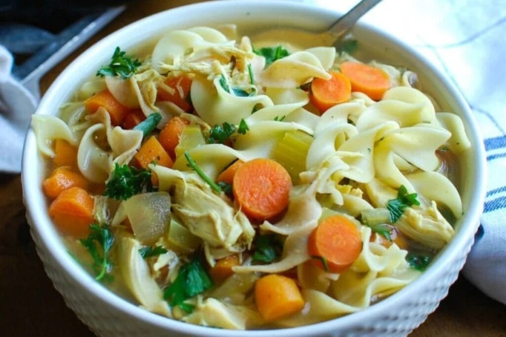 Chicken noodle soup served in a bowl.
