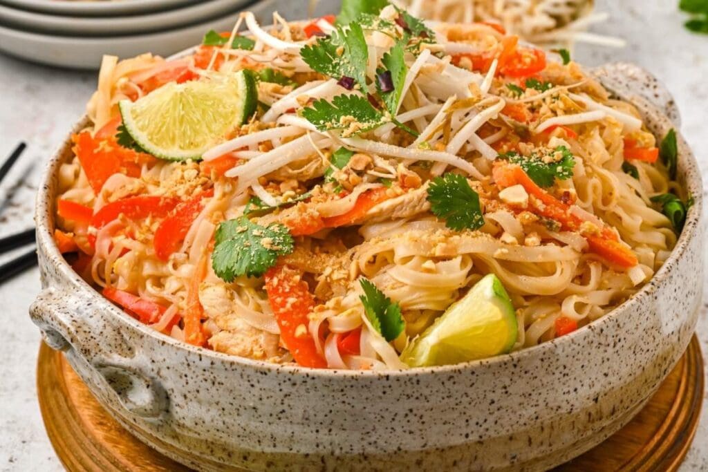 Chicken pad thai noodles in a bowl.