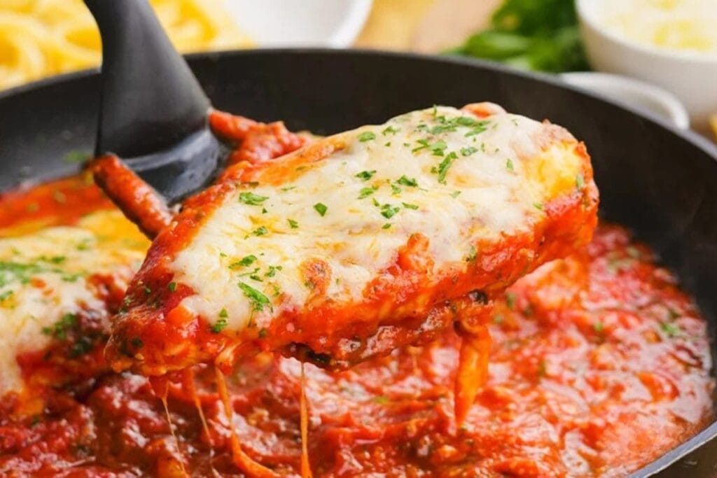Chicken parmesan pasta on a spatula.