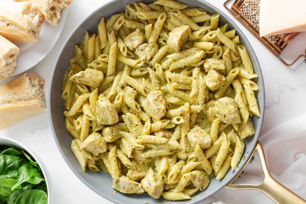 Chicken pesto pasta in a skillet.