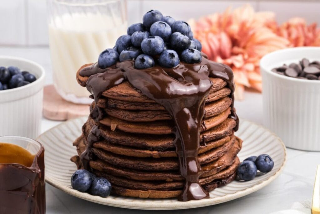 Chocolate pancakes served on a plate.