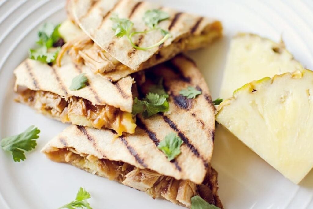 Crock pot BBQ chicken pineapple quesadillas on a plate.