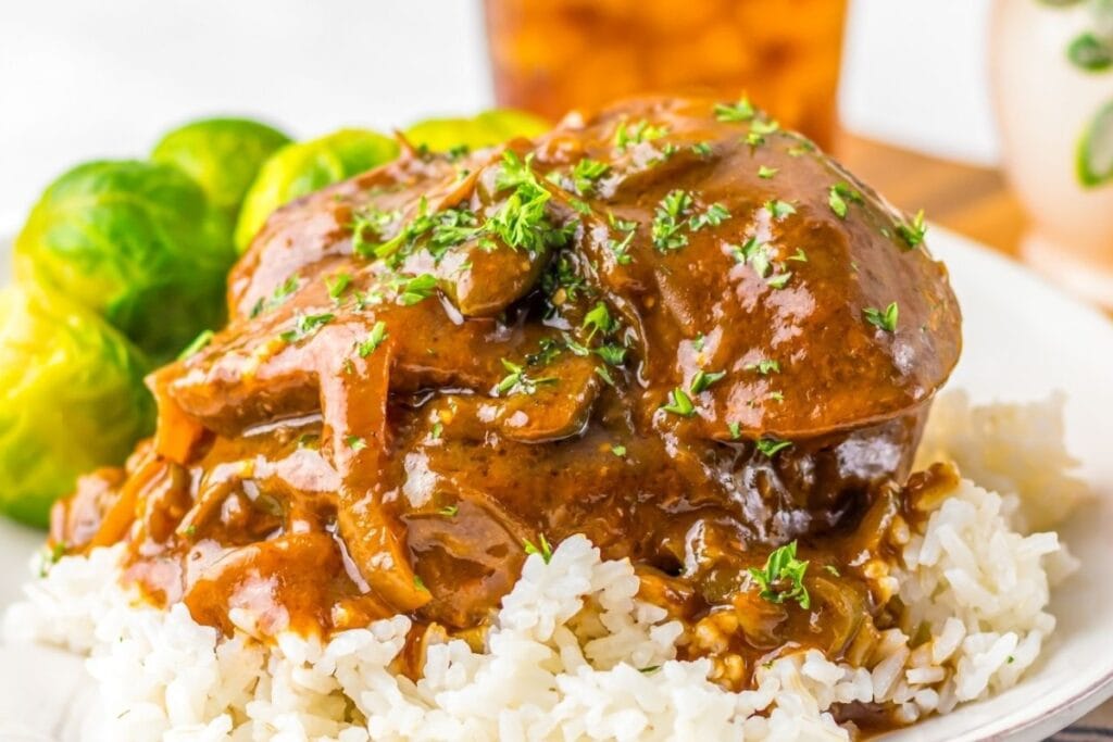 Crockpot smothered steak served over rice.