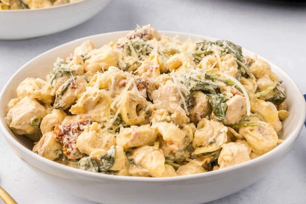 Crockpot Tuscan chicken tortellini in a bowl.