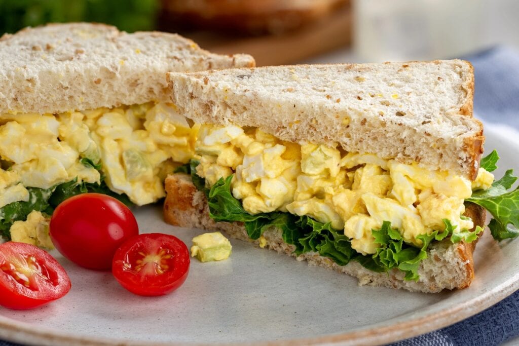 Egg salad sandwiches on a plate.