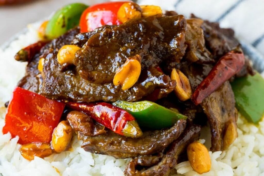 Kung Pao beef served over rice in a bowl.
