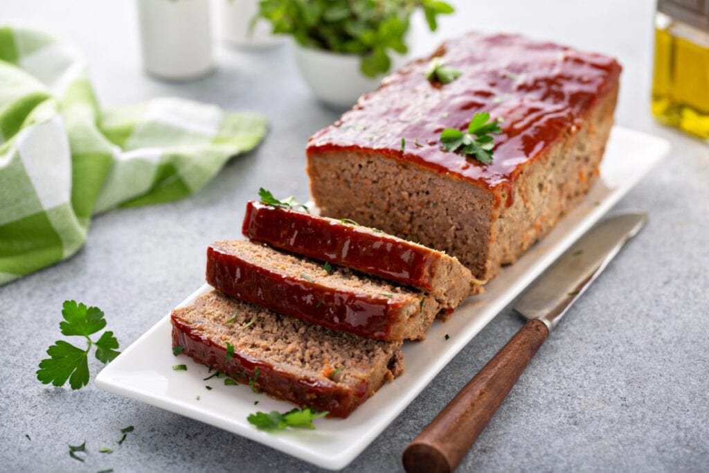 Meatloaf with ketchup glaze on a plate.