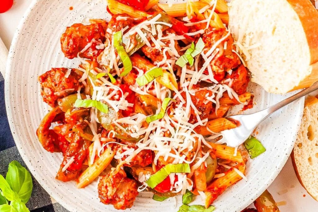 Sausage and peppers pasta on a plate.