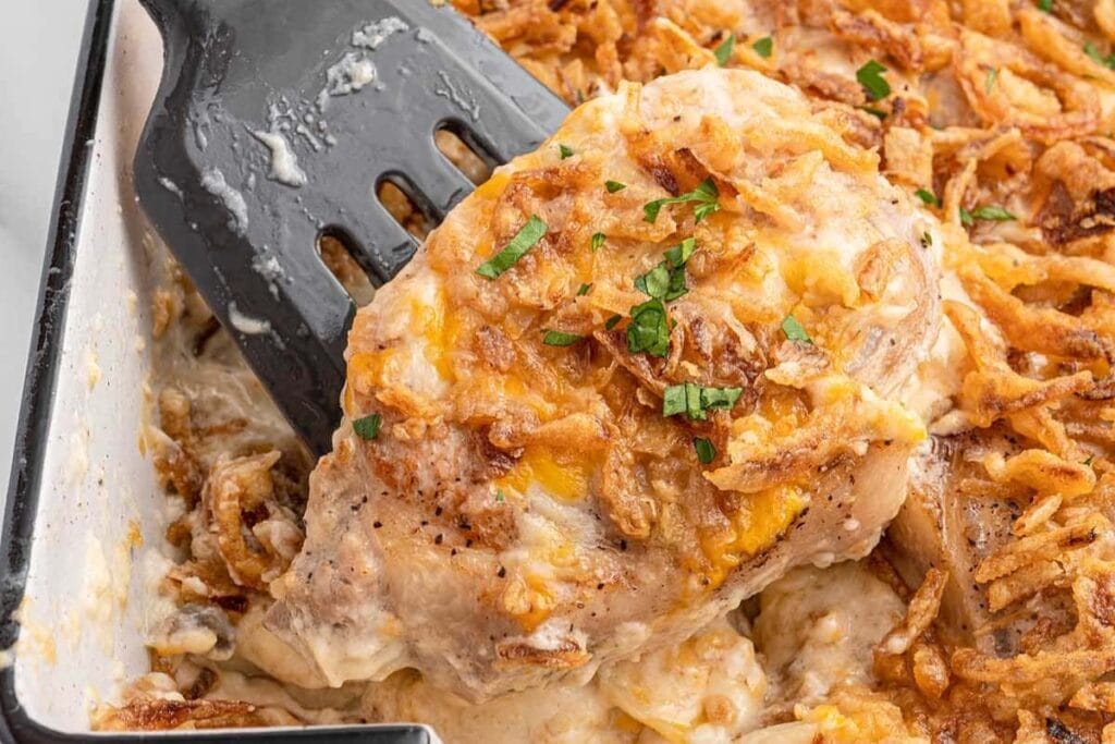 Pork chop casserole on a spatula.