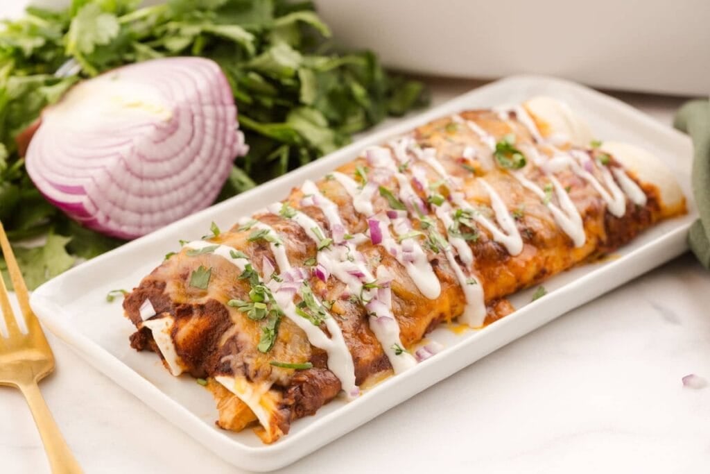 Rotisserie chicken enchiladas on a plate.