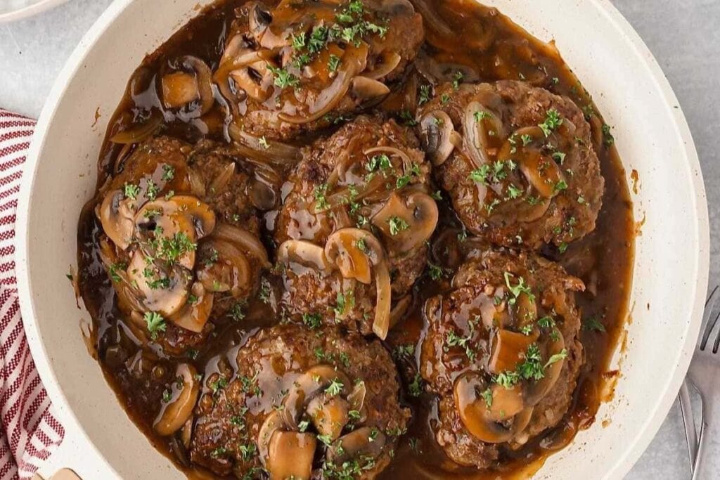 Salisbury steak in a skillet.