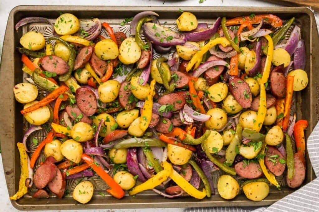Sausage and vegetables roasted on a sheet pan.