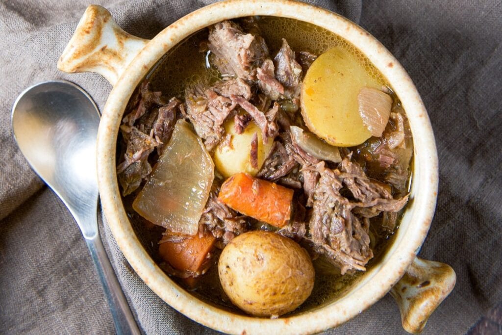 Slow Cooker Pot Roast with carrots and potatoes in a bowl.