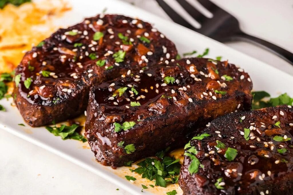Slow cooker sriracha honey garlic pork chops on a plate.