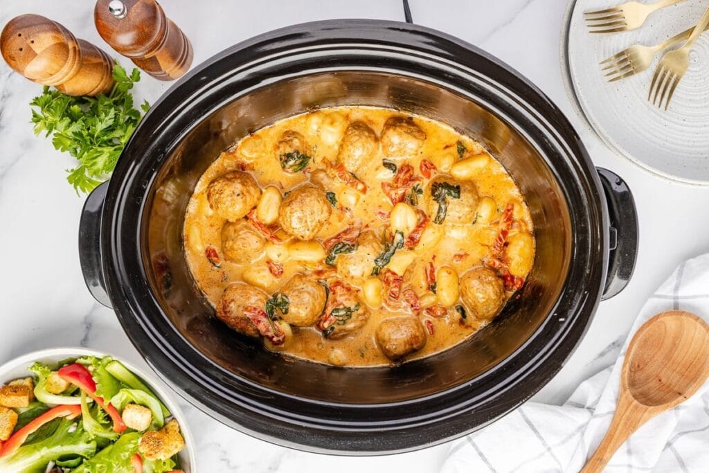 Tuscan meatballs with gnocchi in a slow cooker.