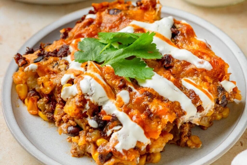 Sliced taco tater tot casserole on a plate.