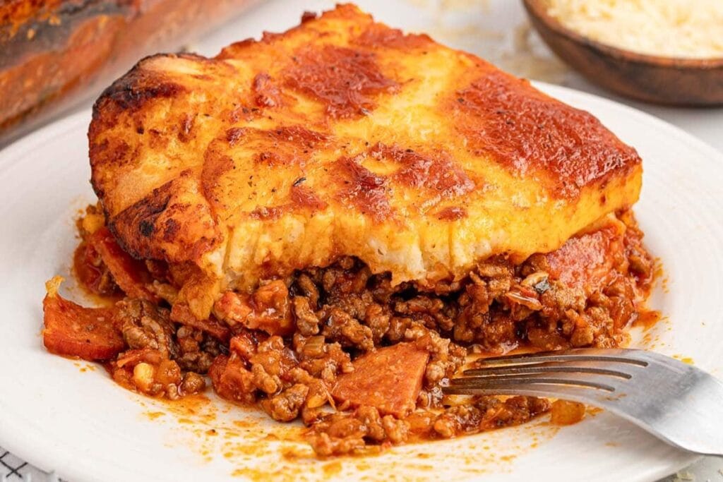 Upside down pizza on a plate.