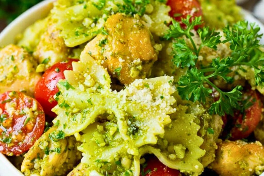 A close up shot of chicken pesto pasta.
