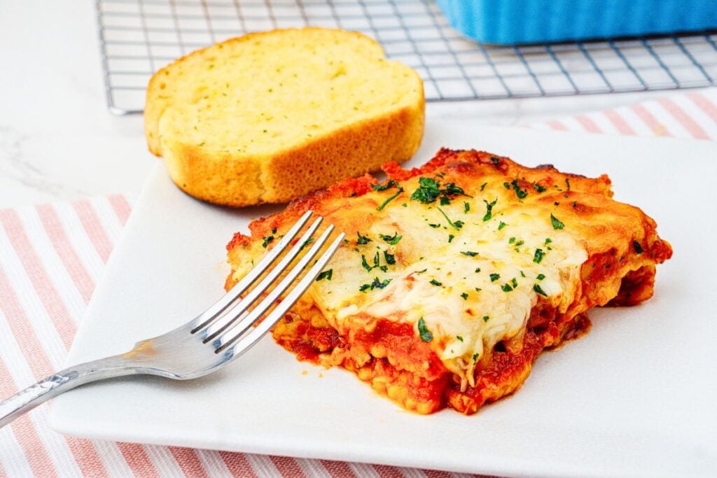 A close up shot of lasagna with ravioli.