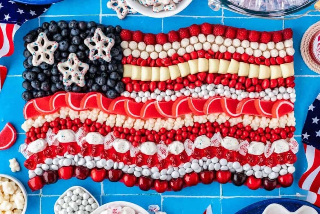 American flag dessert board with candies and berries.
