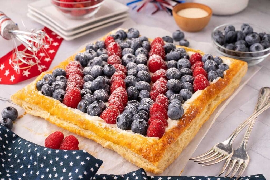 Berry cheesecake puff pastry tart with fresh berries.