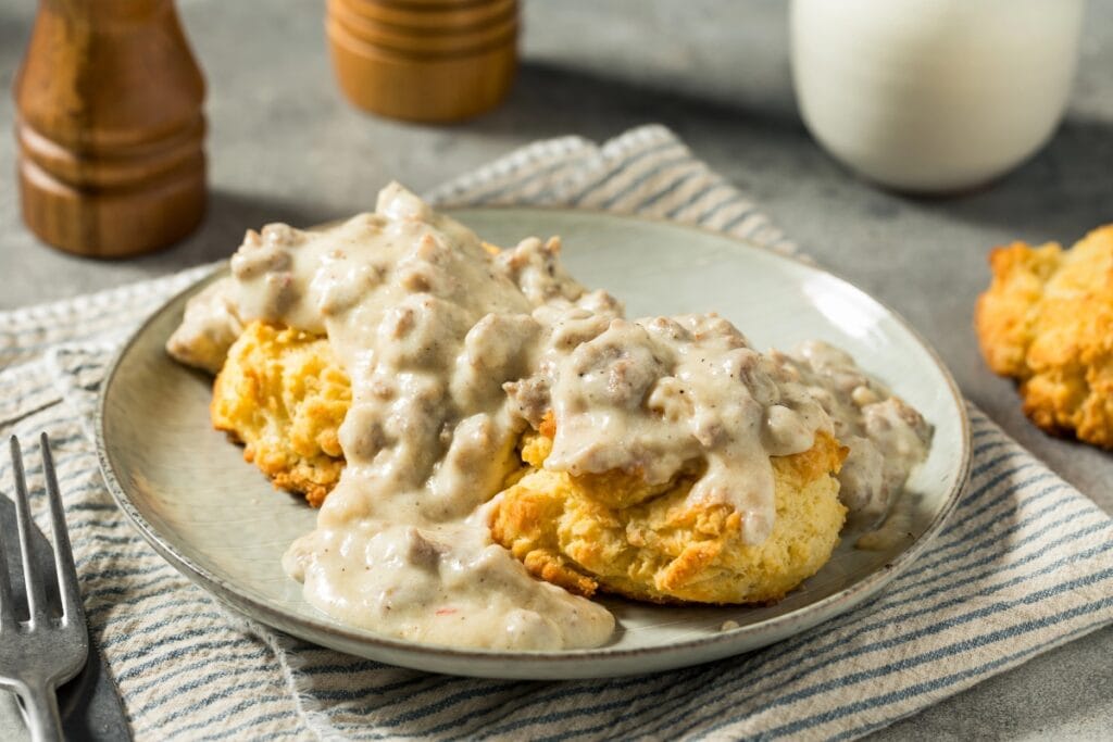 Biscuits and gravy on a plate.