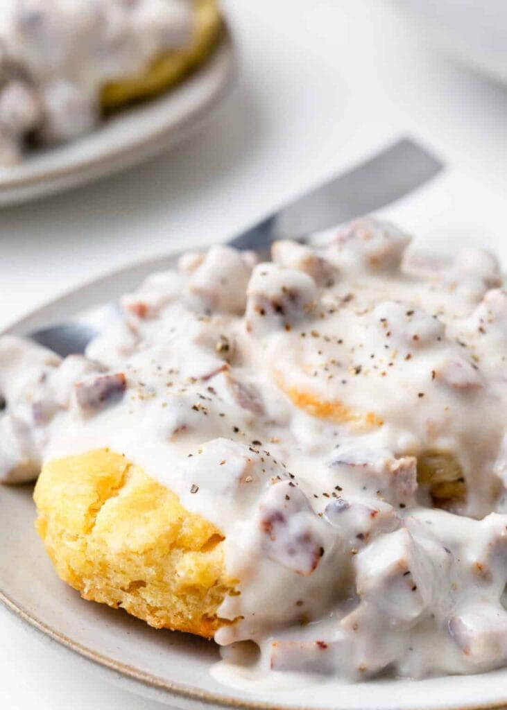 Biscuits and gravy on a plate.