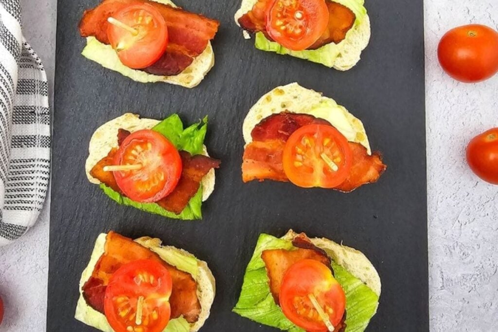 BLT bites on a black serving board.