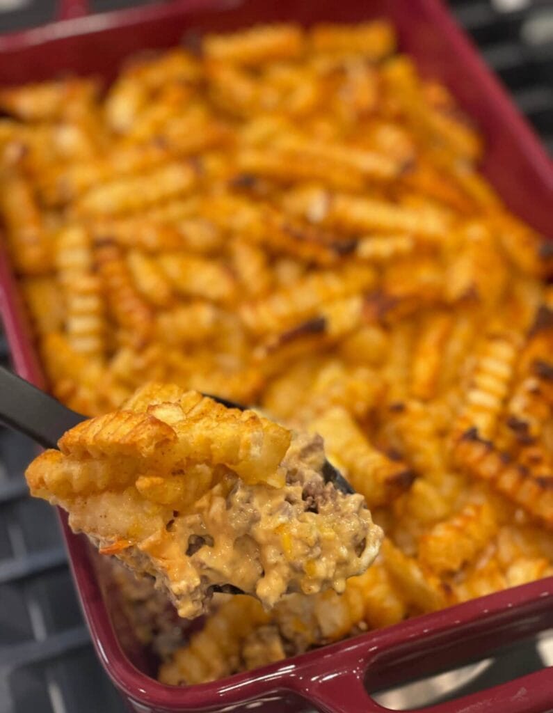 Cheeseburger French fry casserole on a spoon.