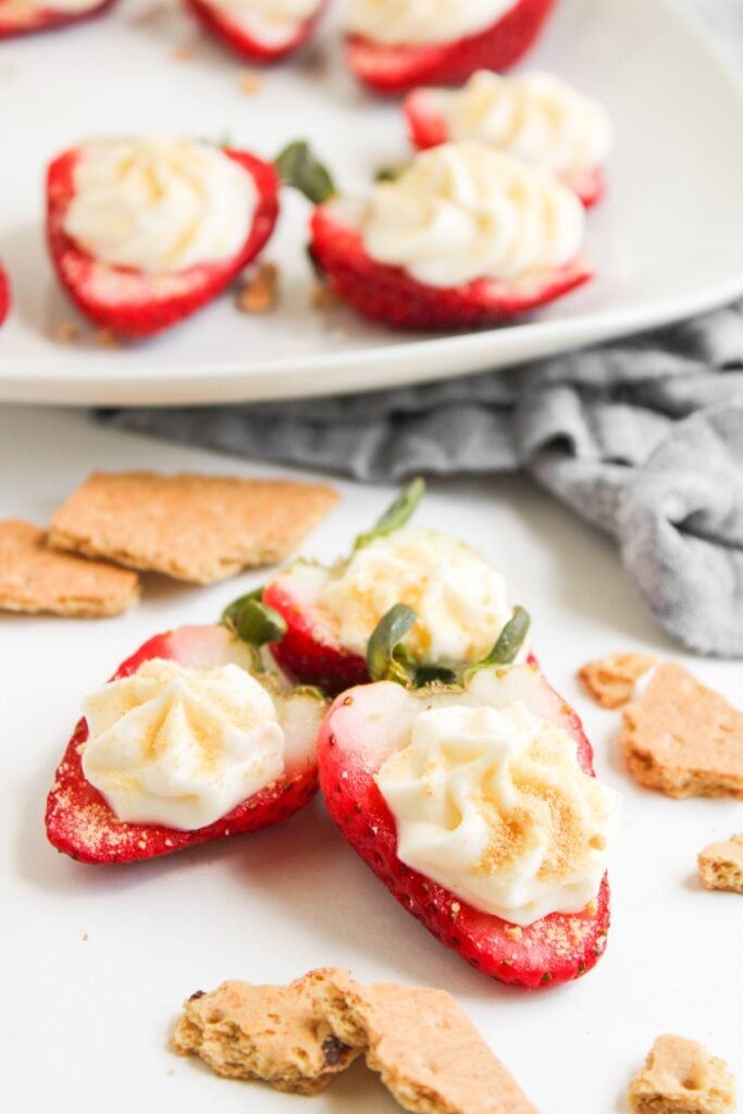 Cheesecake deviled strawberries on a plate.