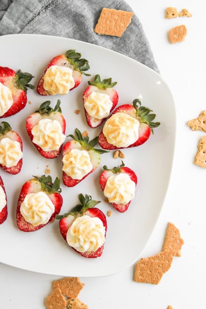Cheesecake deviled strawberries on a plate.