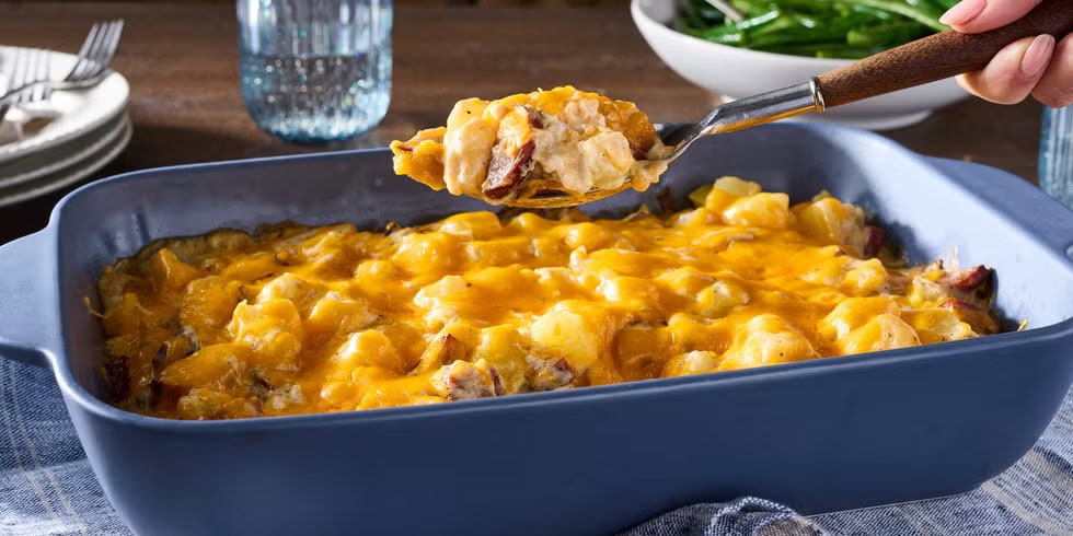 Cheesy kielbasa and potato casserole in a baking dish.