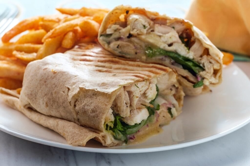 Chicken caesar wrap on a plate.
