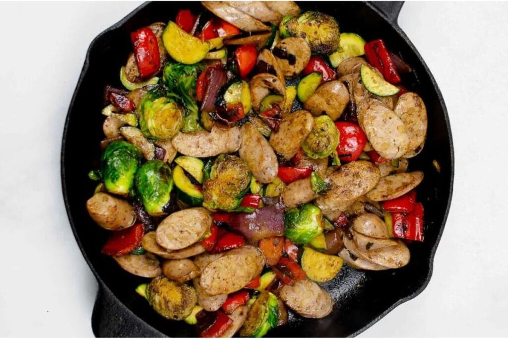 Chicken sausage veggie stir fry in a skillet.