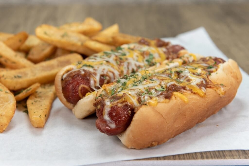 Chili cheese dog with fries.