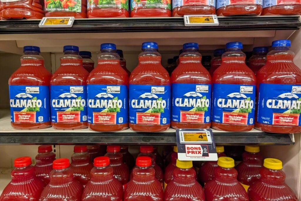 Clamato juice bottles on store shelves.