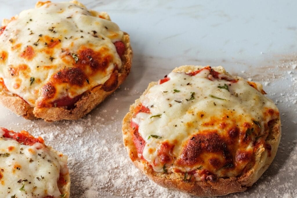English muffin pizza on a table.