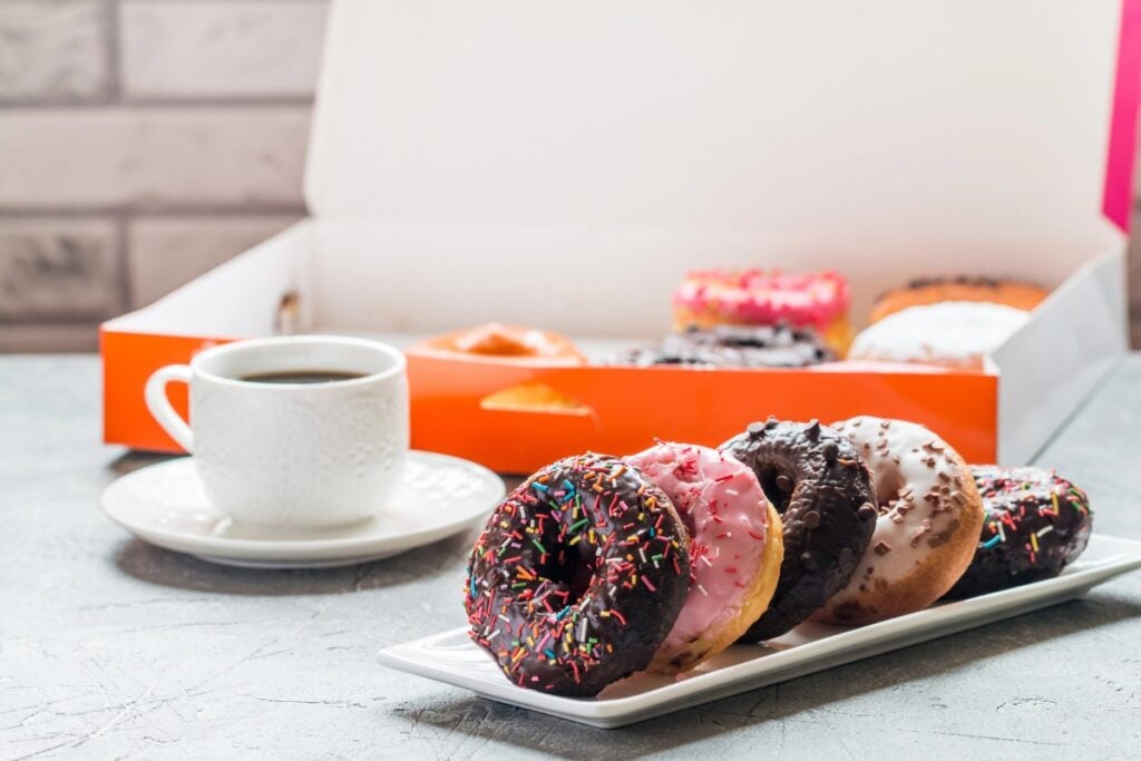 Assorted donuts with coffee on a table.