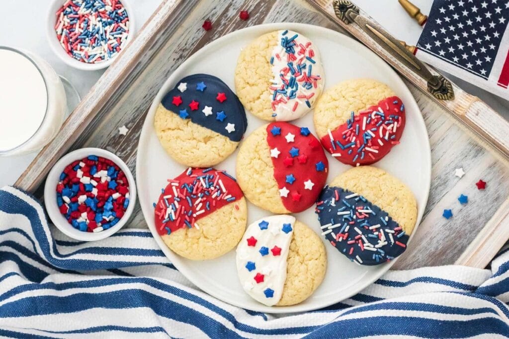 Fourth of July cake mix cookies with patriotic frosting and sprinkles.