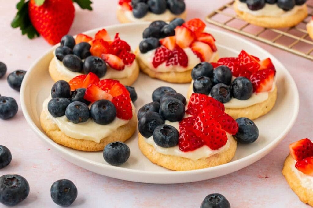 Fruit pizza cookies on a plate.