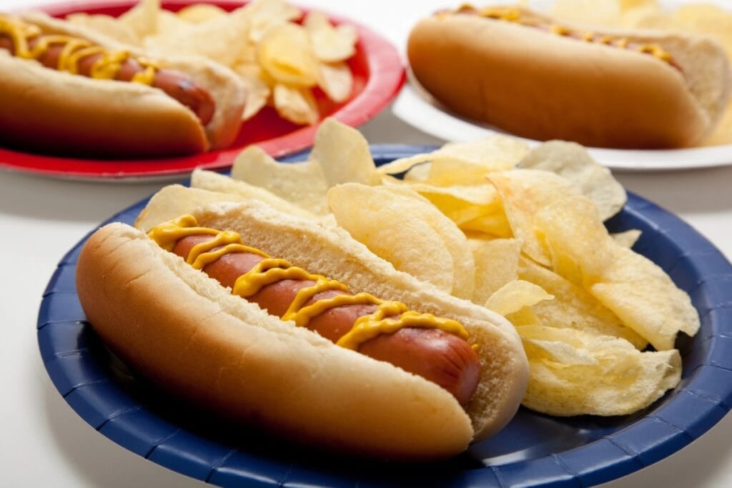 Hot dogs and chips on a plate.