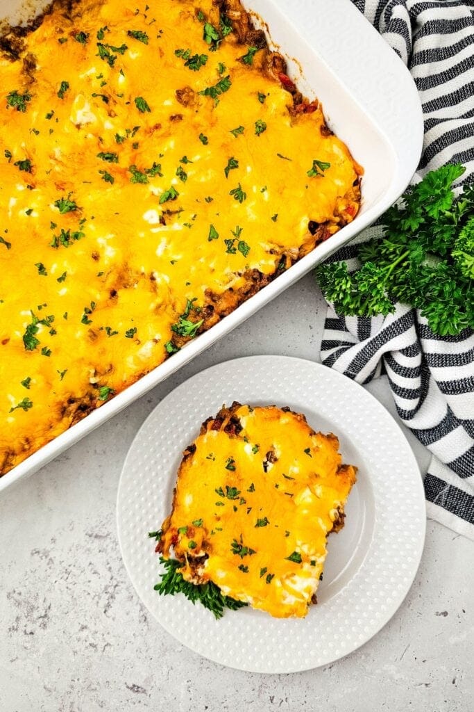 John Wayne casserole topped with melted cheese in a baking dish.