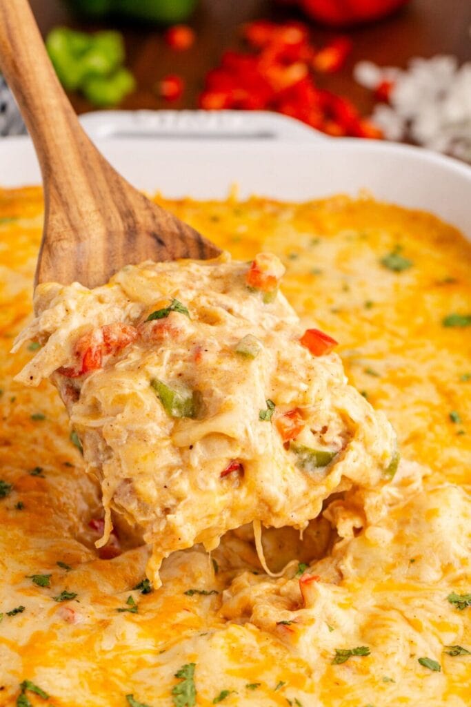 Close-up of King Ranch chicken casserole on a wooden spoon.