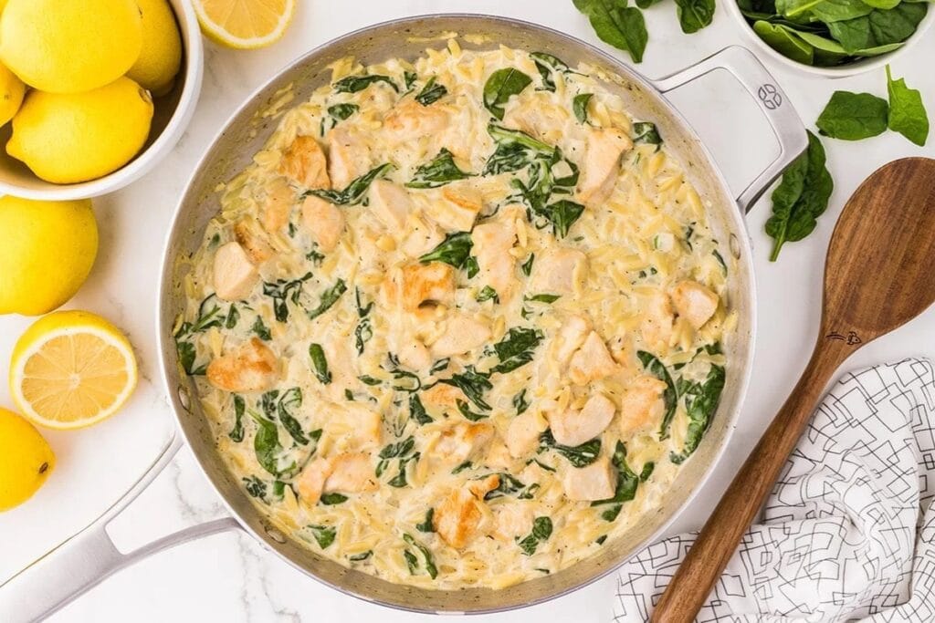 Lemon chicken orzo in a skillet.