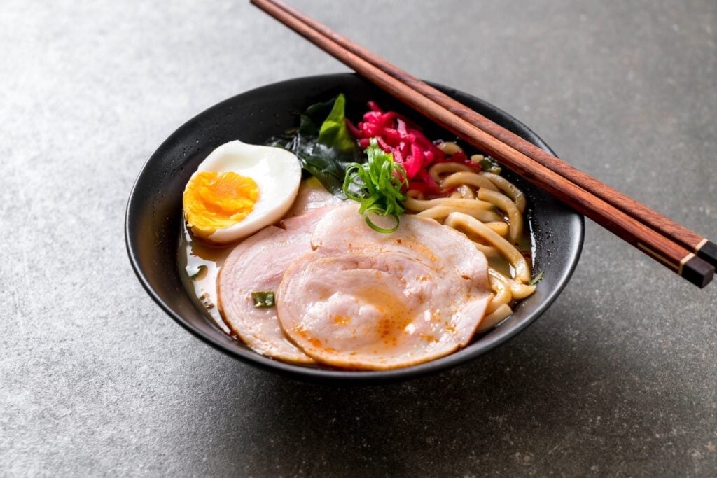 Bowl of ramen with soft boiled egg and toppings.