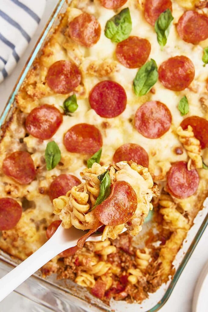 Pizza casserole topped with melted cheese in a baking dish.