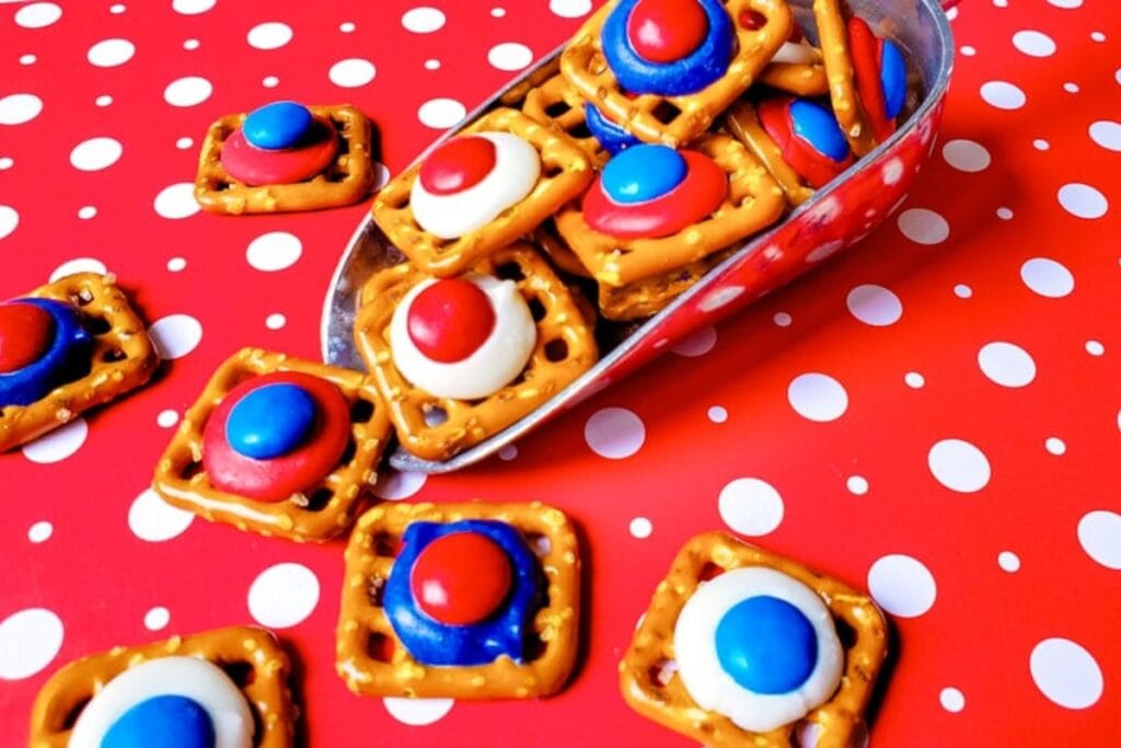 Close-up of red, white, and blue pretzel bites with candy toppings.