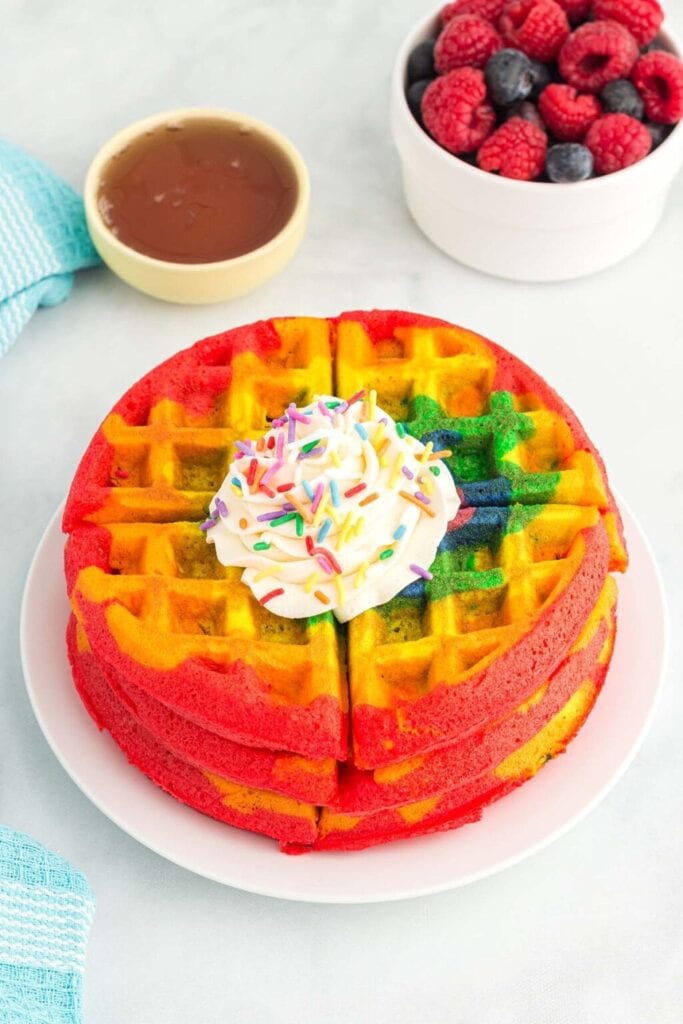 Rainbow waffles on a plate.